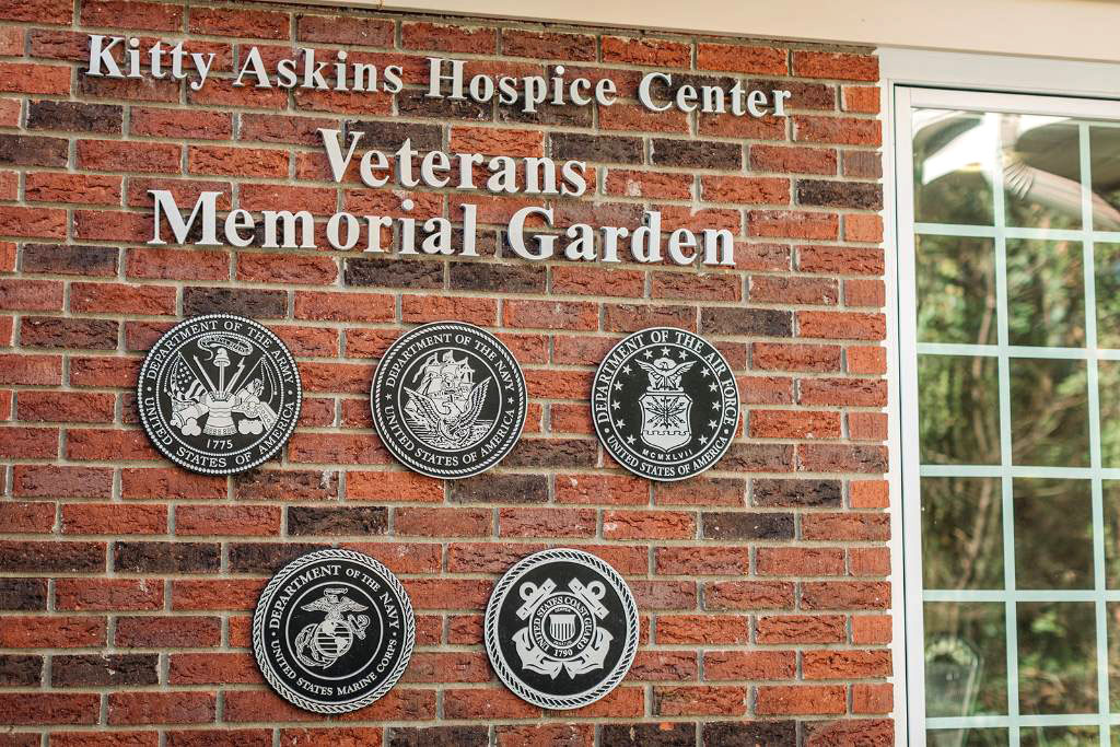 A Brick Wall With The Words Kitty Askins Hospice Center Veteran Memorial Garden