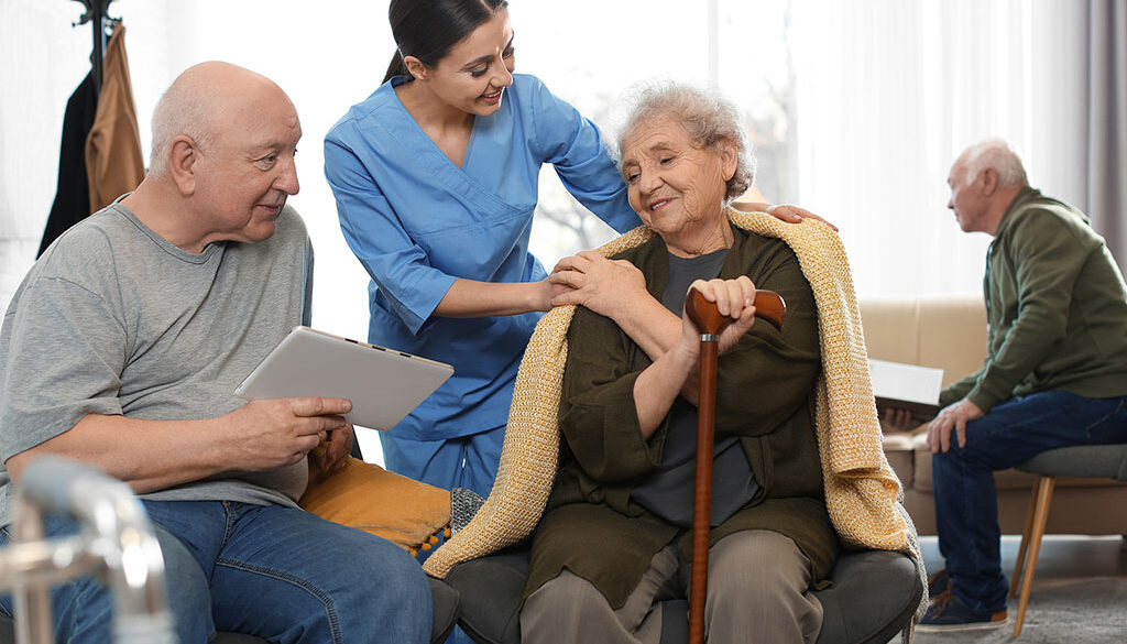 A Hospice Caregiver Wrapping a Blanket Around a Senior Woman in Hospice Care Non-profit vs For-Profit Hospice