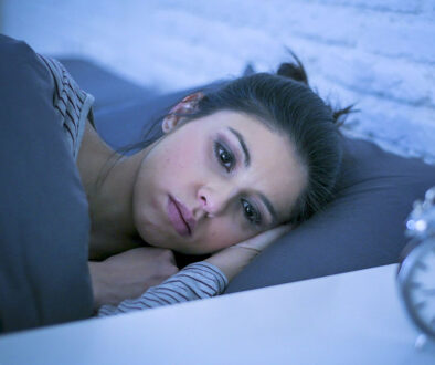 Closeup Of A Woman Laying In Bed At Night Looking Sad Experiencing The Physical Effects Of Grief