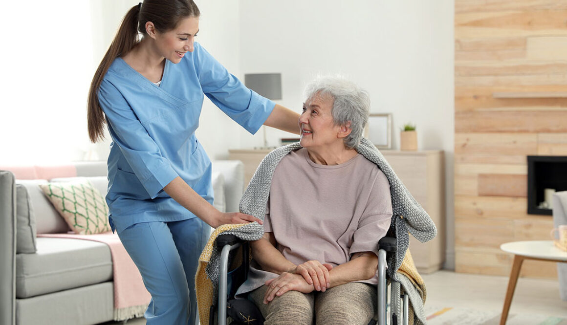 A Hospice Nurse Putting a Blanket on a Senior Woman Sitting in a Wheelchair Hospice and Parkinson’s Disease